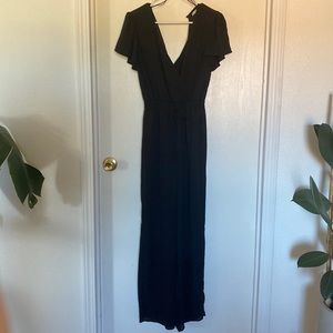 Small black womens jumpsuit with deep belly neck and back line and elastic waist